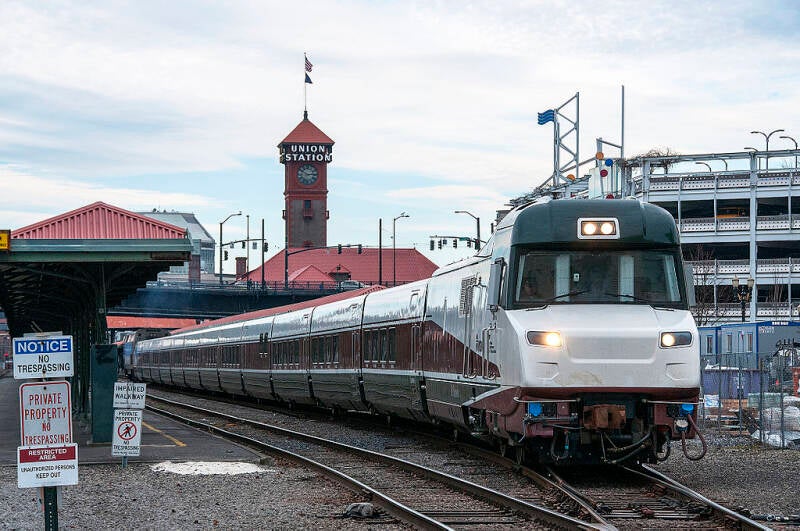 A Talgo Series 8 trainset departs Portland Union Station with the engineer controlling the train from the cab located inside the power car.