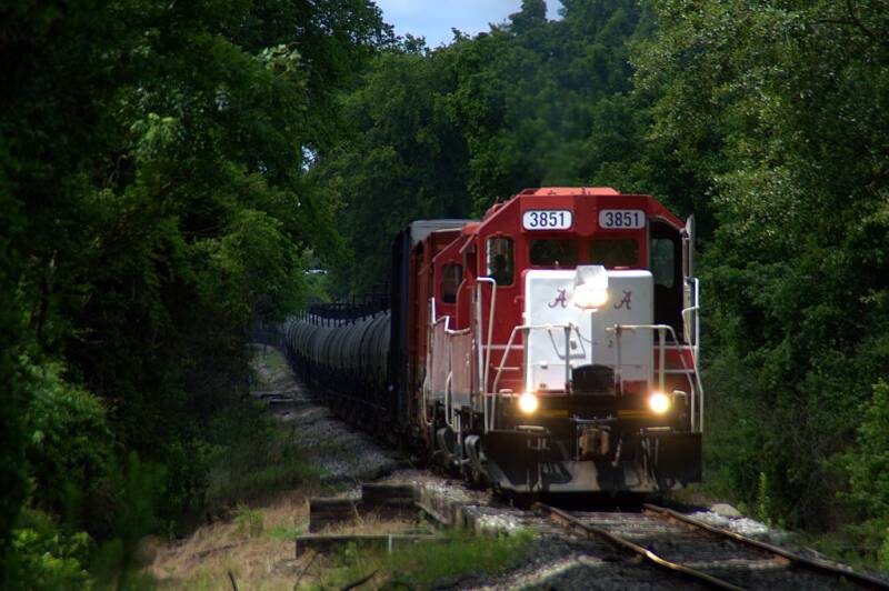 Alabama Southern Railroad EMD GP35 diesel locomotives No. 3851 and No. 3839 lead a freight train through Tuscaloosa on June 20, 2016.