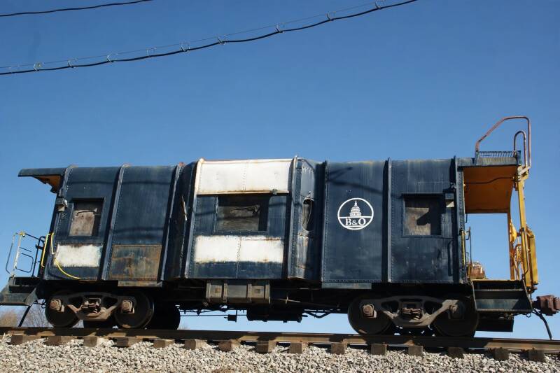 a blue and white steel bay window caboose