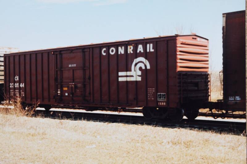 a brown boxcar with Conrail markings