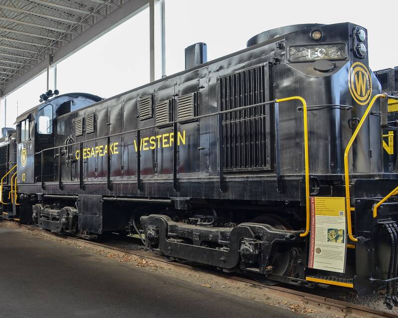 an older dark blue diesel locomotive with yellow markings