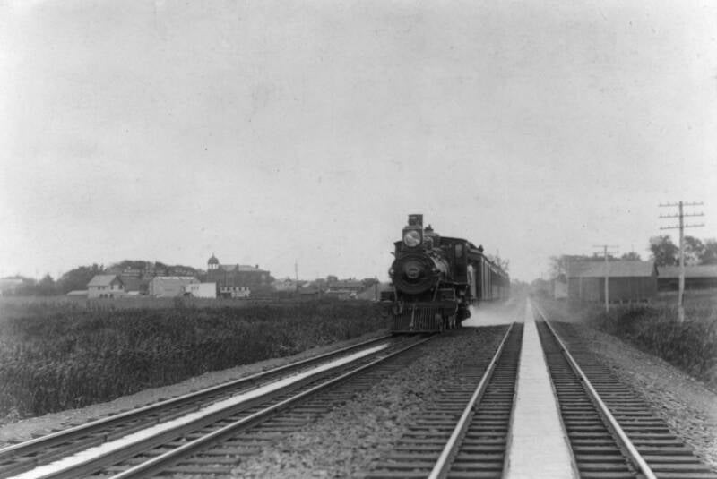 Double tracks and tanks (N. Y. & L. B. R. R.) near Long Branch, N. J. engine scooping water; train running 25 miles an hour, 1894.