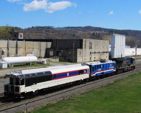 two special railcars pulled by a locomotive