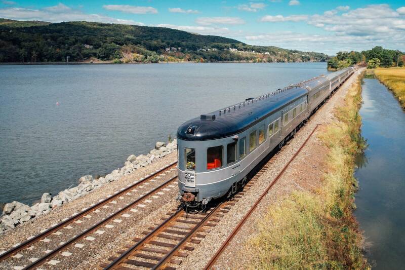 a train with 40's era passenger cars on the Water Level Route