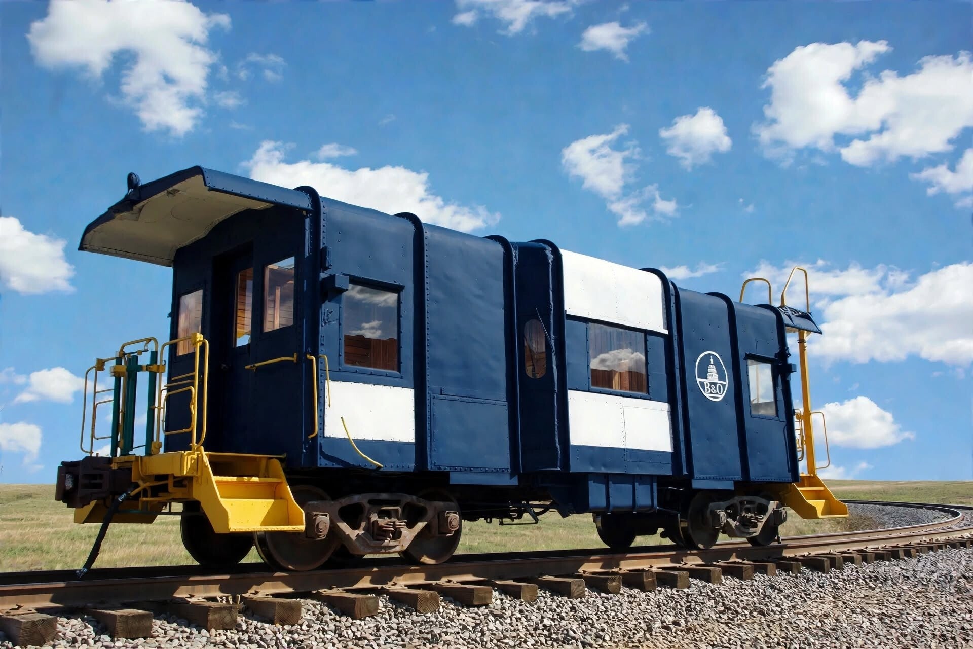 a blue and white steel bay window caboose