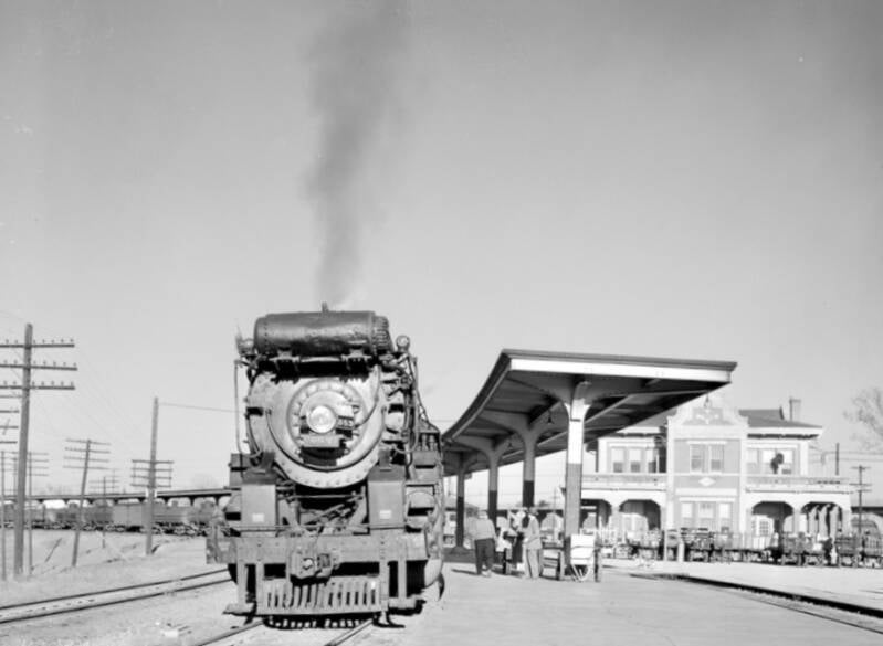 a steam locomotive with a large cylindrical tank above the smoke box.
