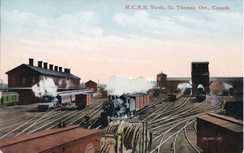 steam locomotives and freight and passenger trains in a vintage rail yard.