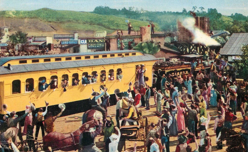 Photo postcard with a scene from the filming of The Harvey Girls (1946). This scene includes a Santa Fe train circa 1890s.
