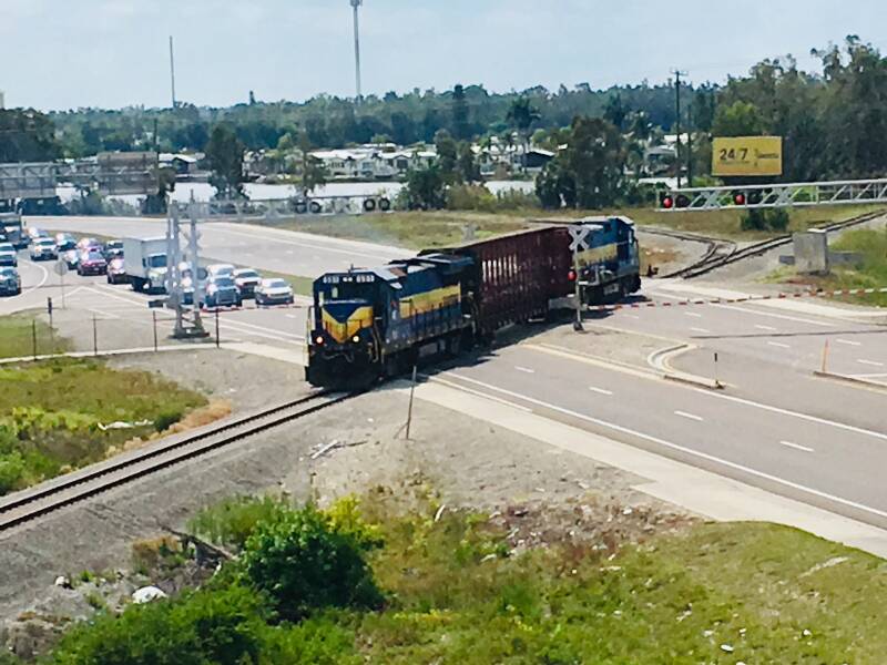 Local freight train crossing Alico Road near the Baker Spur junction south of Fort Myers.