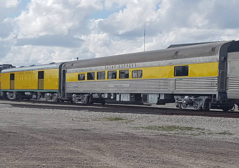 The two cars used on the Sugar Express; The Miami Locks open-air car (left) and the Palmdale lounge car (right).