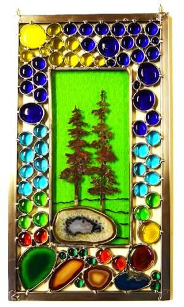 Stained glass panel with copper overlay trees.