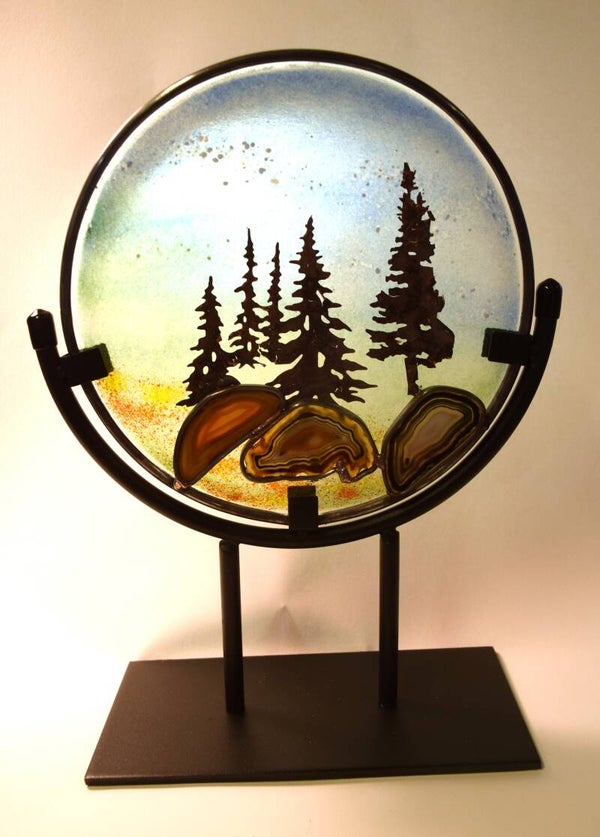 Round copper overlay panel on a stand.