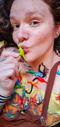 Maker covered in toy dinosaurs