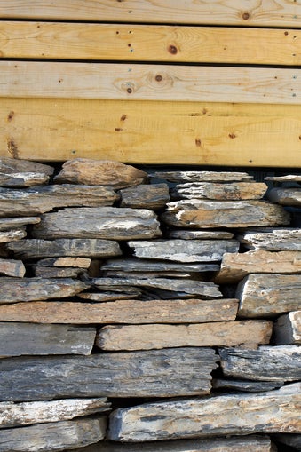 Rock wall and wood fence
