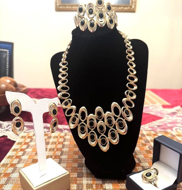 Beautiful Gold Tone Necklace, Bracelet. Ring and Earrings With White Stones and Large Connecting Ovals Black Stones