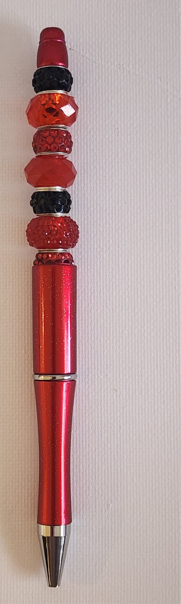 Red shiny pen with red and blingy black beads