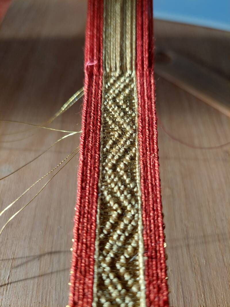 Closeup van de kaartweefband in rood en geel zijde.