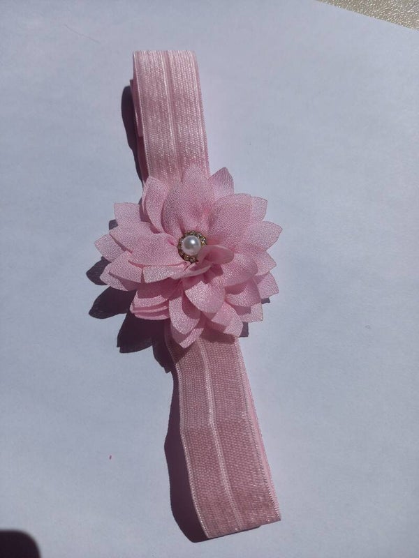 Roze breder haarbandje met een leuke roze bloem