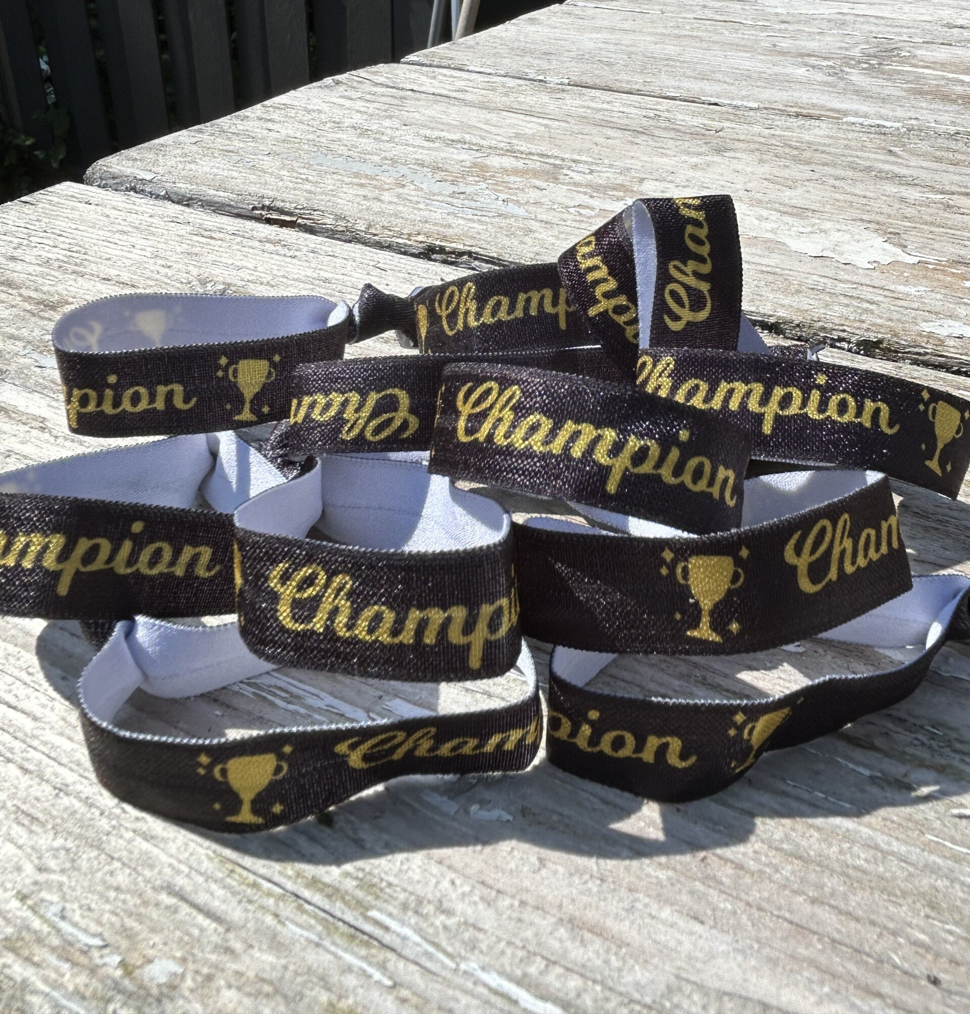 Elastische armband/haarelastiek Champion zwart met goud