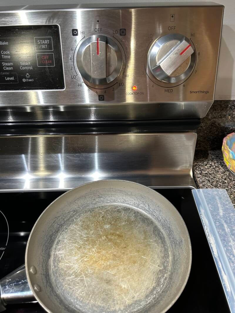 Empty skillet preheating on stovetop.