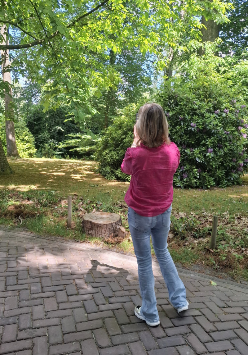 Deelnemer maakt foto met telefoon tijdens fotografie workshop – creatief leren fotograferen.