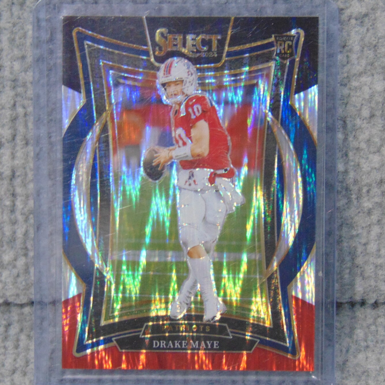 2024 Panini Select # 27 Drake Maye (RC) Red and Blue Shock Refractor.