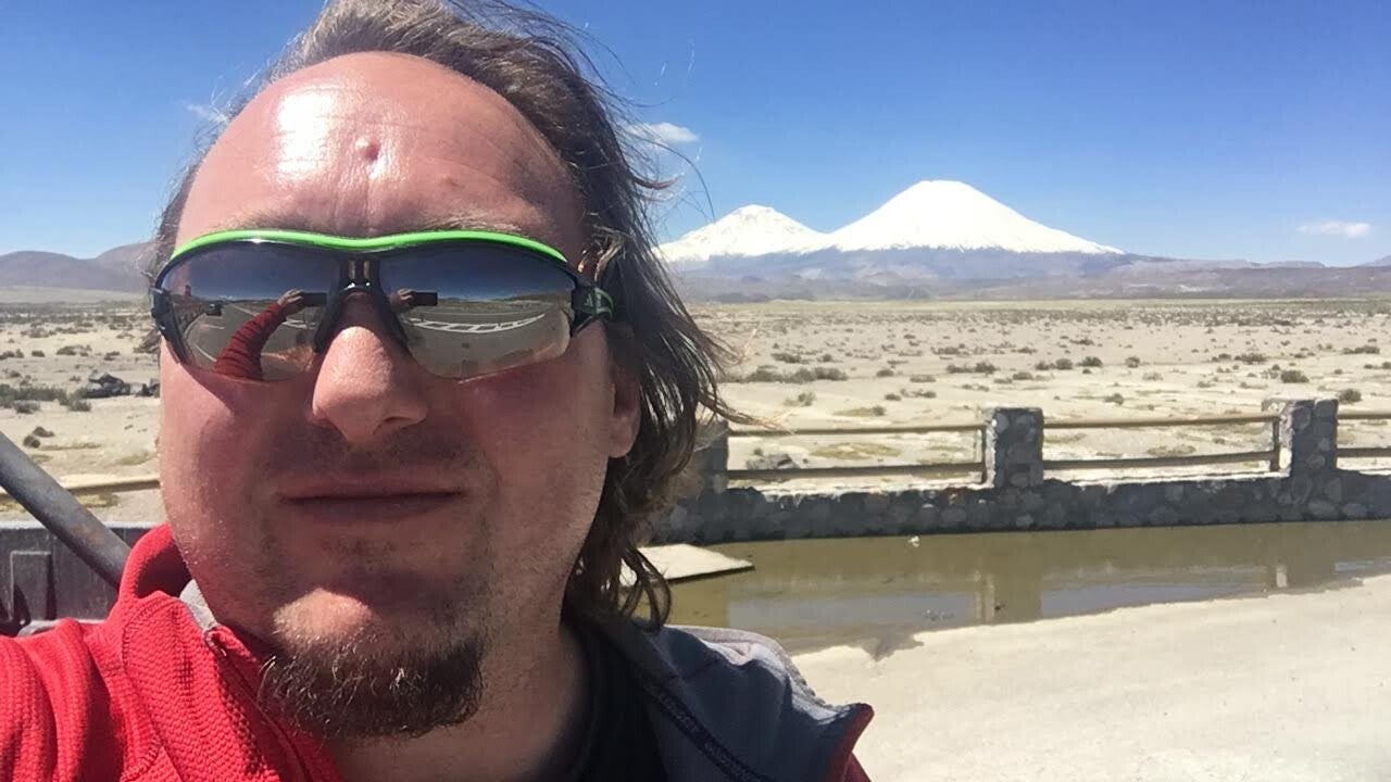 Tour Manager Chile Gerhard Bacher with volcanoes in the Atacama Desert