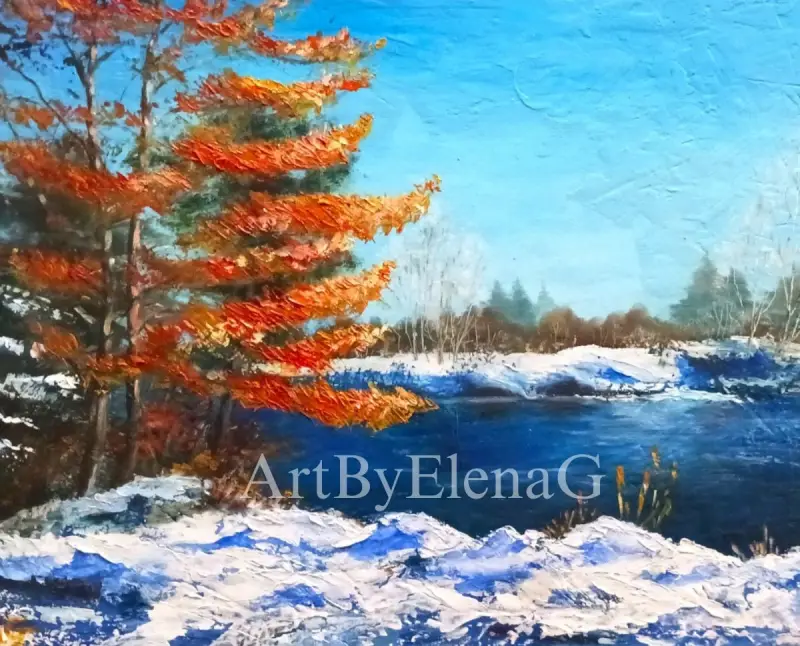 The blue river, blue sky, and white yet loose snow serve to accentuate the flaming red pine trees in the foreground. Landscape by ElenaG.