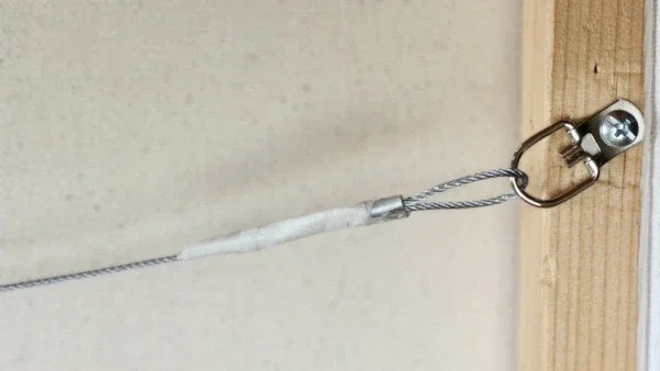 The back view of the painting with a D-ring hanging system.