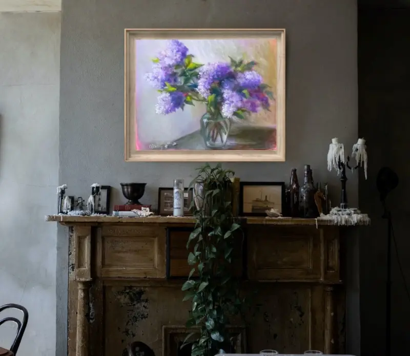 A soft impressionist oil painting displaying a dense arrangement of purple and violet lilac blossoms inside a clear glass vase is in the interior.