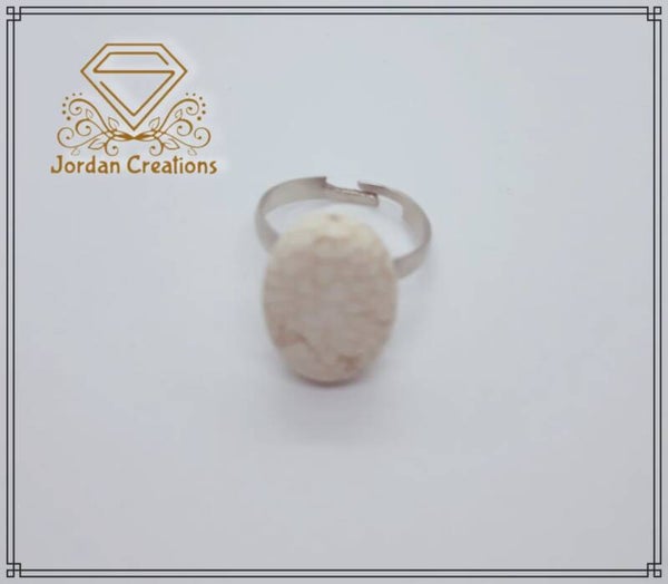 Silver colored ring with white turqois