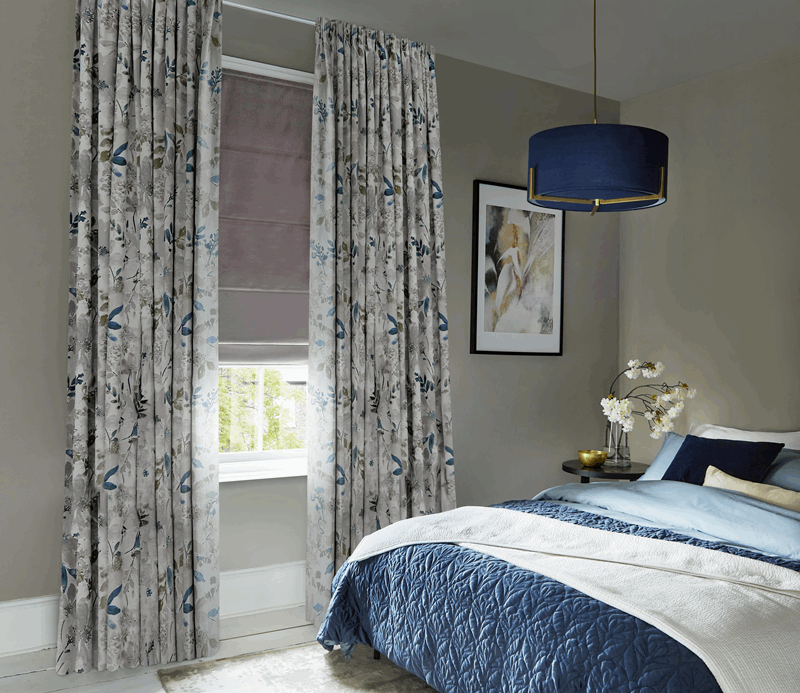 Patterned curtains and plain roman blind