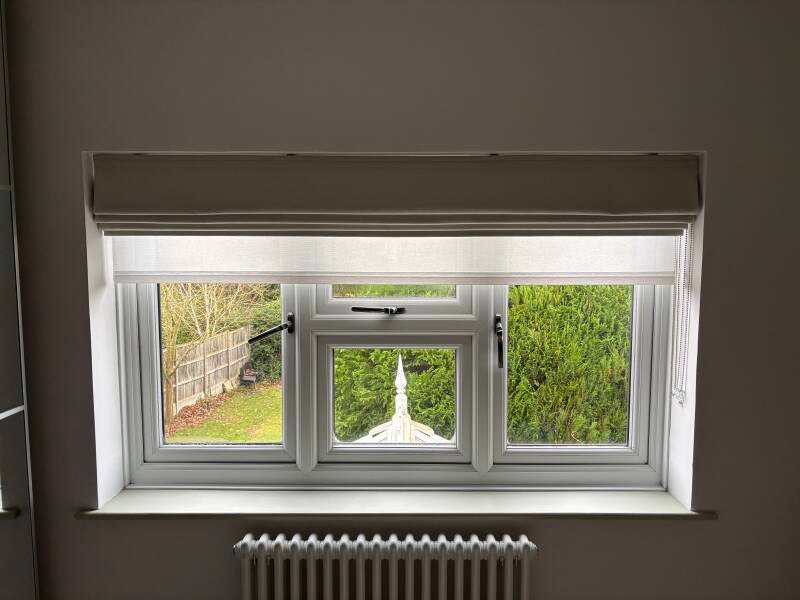 Natural coloured roman blind and white sheer roller blind fitted in Orpington, Kent