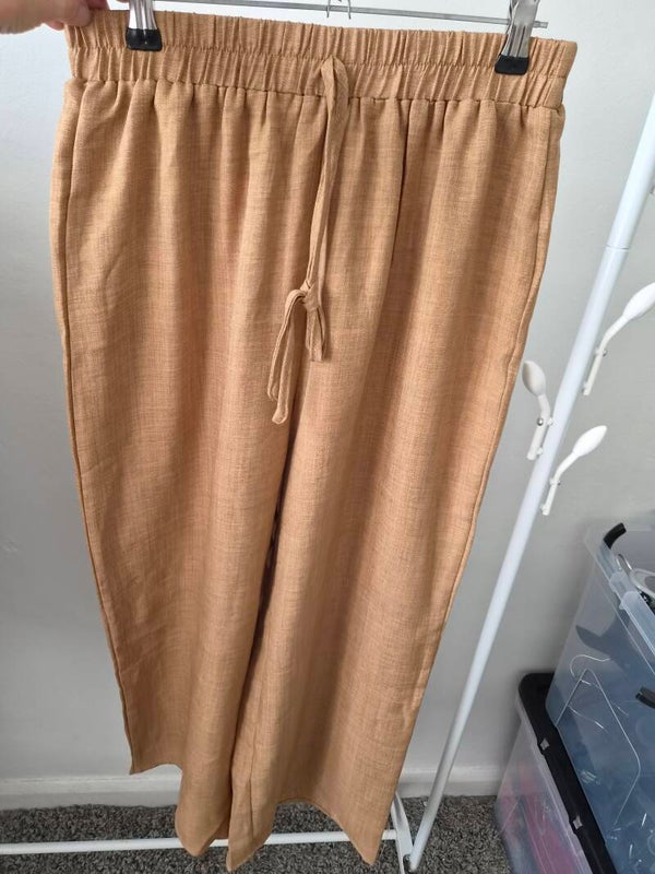 Gold coloured trousers.  Size medium by Shein