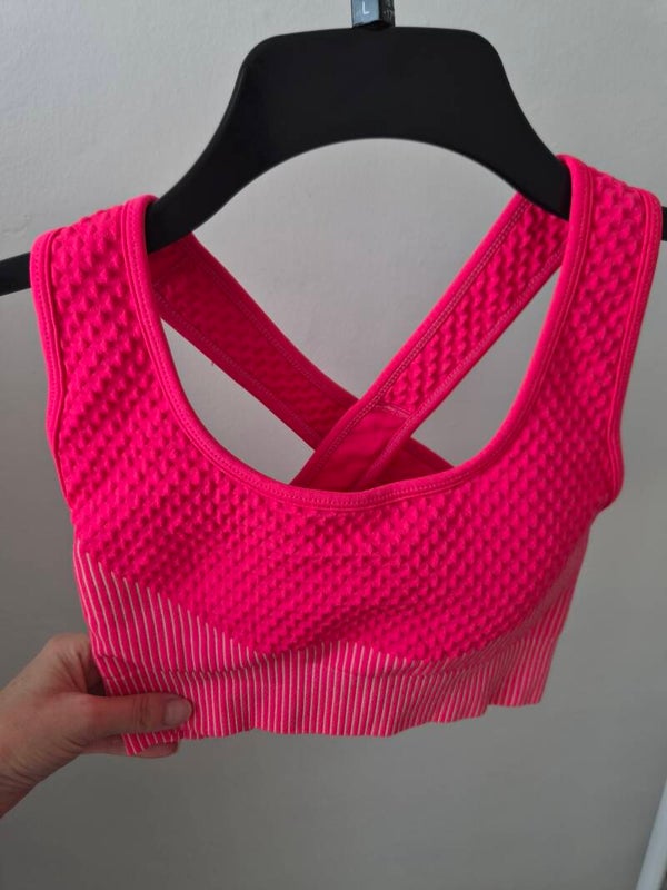Bright pink sports bra. No size but measures an XS