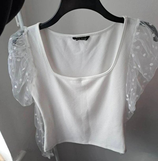White top with long see through sleeves. Size medium by Shein