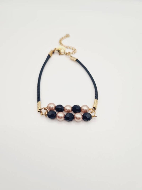 Gouden armband met zwarte sparkles en rosé parels