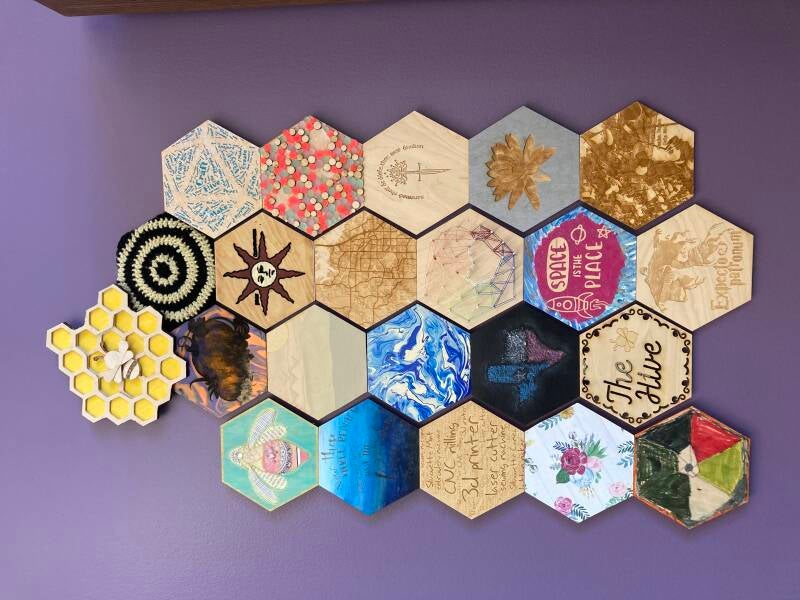 Hexagonal wooden tiles created using Hive Maker Space equipment.