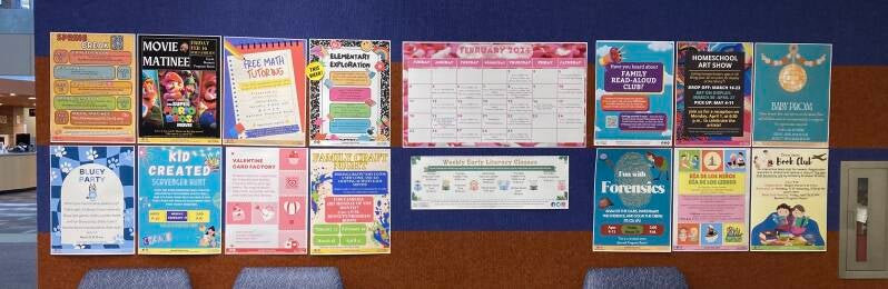 Posters announcing upcoming events attached to a wall.