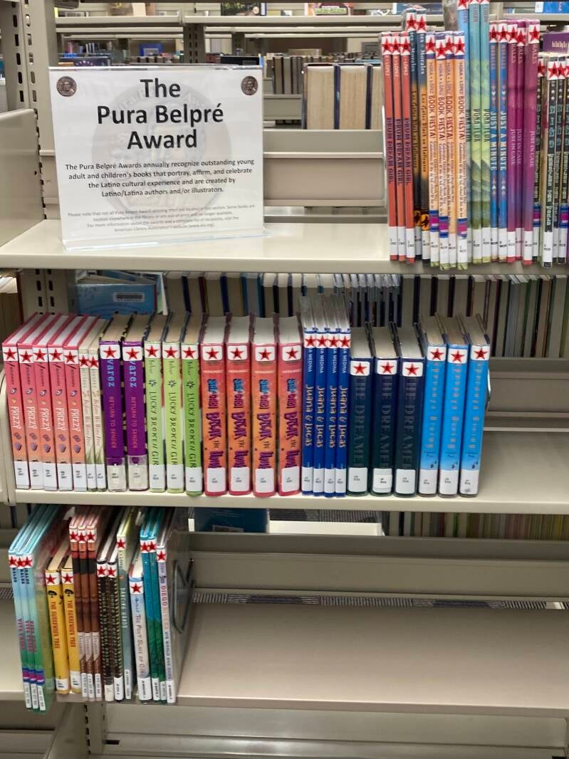 Shelves of Pura Belpre Award books.