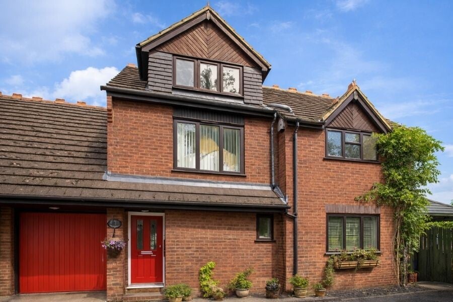Front image of a four bedroom semi-detached house with a garage on Burydell Lane, Park Street