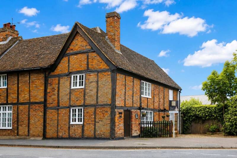 A 17th‑century Grade II listed semi‑detached cottage in Park Street, St Albans, showing the front elevation with brick and timber detailing, tiled roof and cottage‑style frontage.