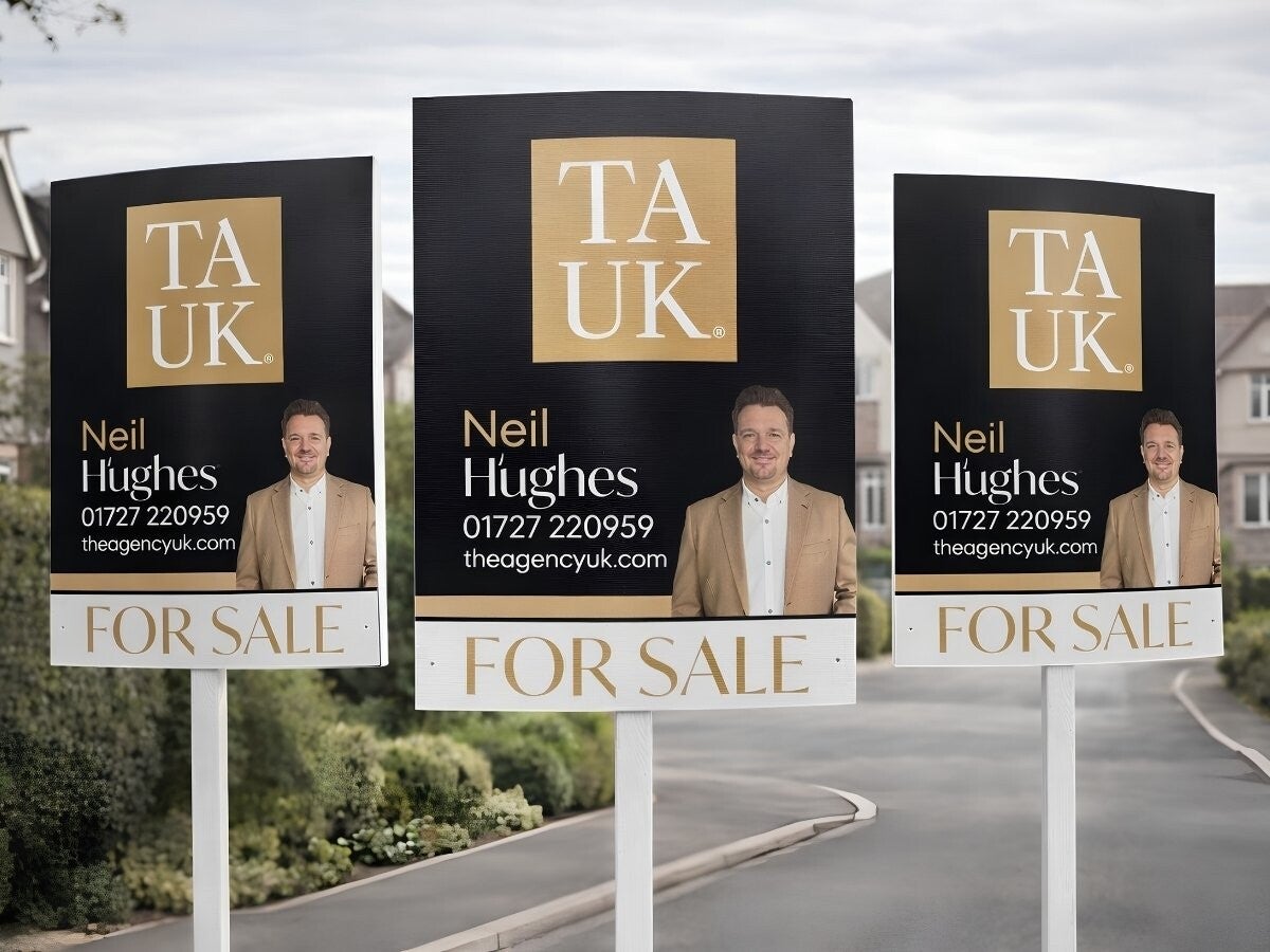 Neil Hughes TAUK  image of three Sold Boards in a row outside a residential strett.