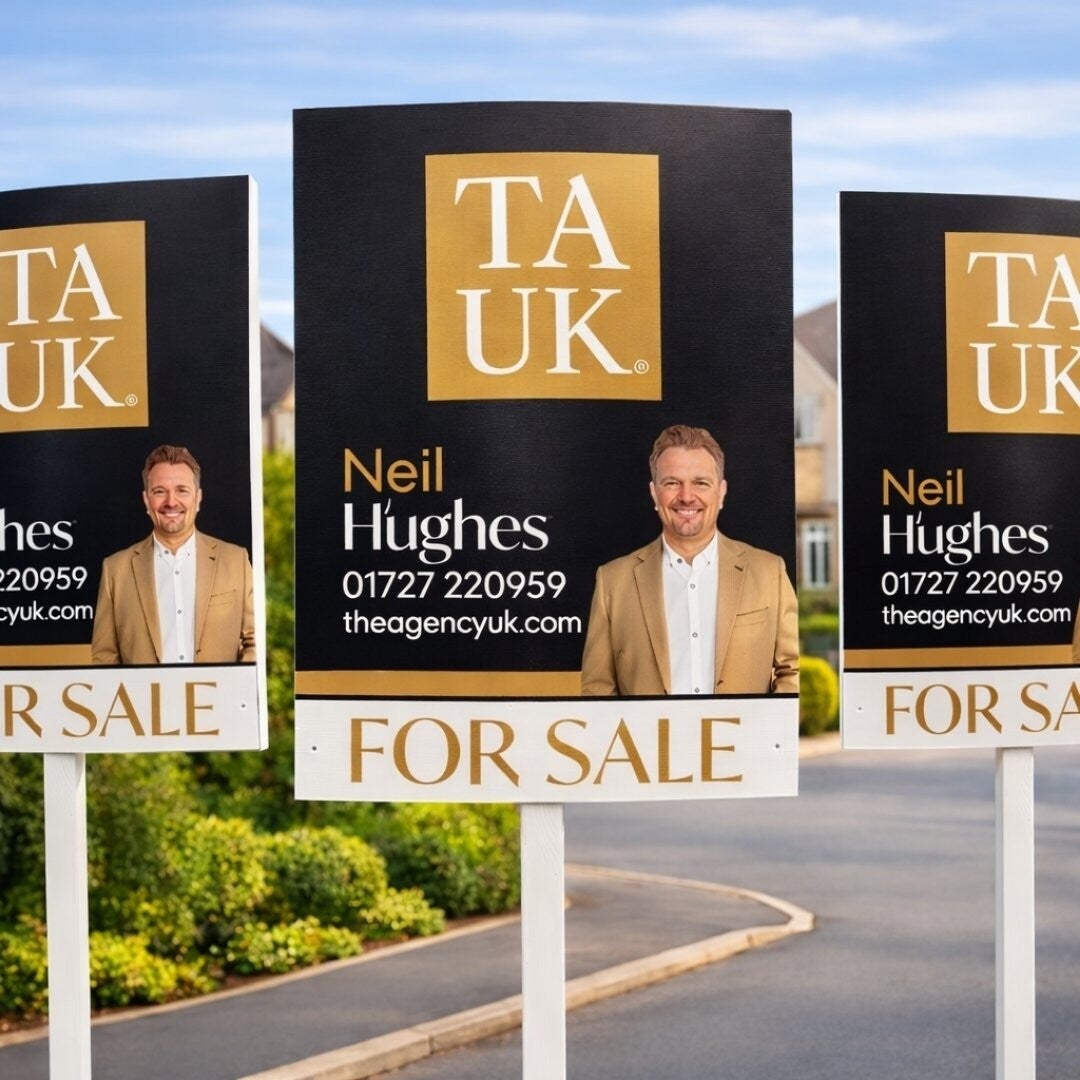 Three TAUK For Sale boards displayed in an upscale St Albans neighborhood, featuring Neil Hughes branding and contact details.