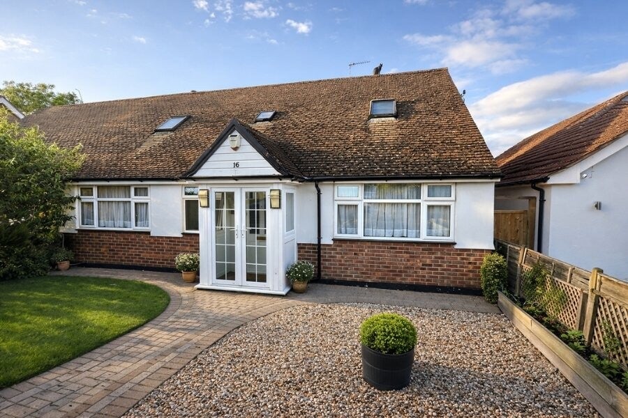 Front elevation of a spacious semi‑detached chalet bungalow on The Mall, Park Street, showing the landscaped frontage, driveway and quiet cul‑de‑sac setting.
