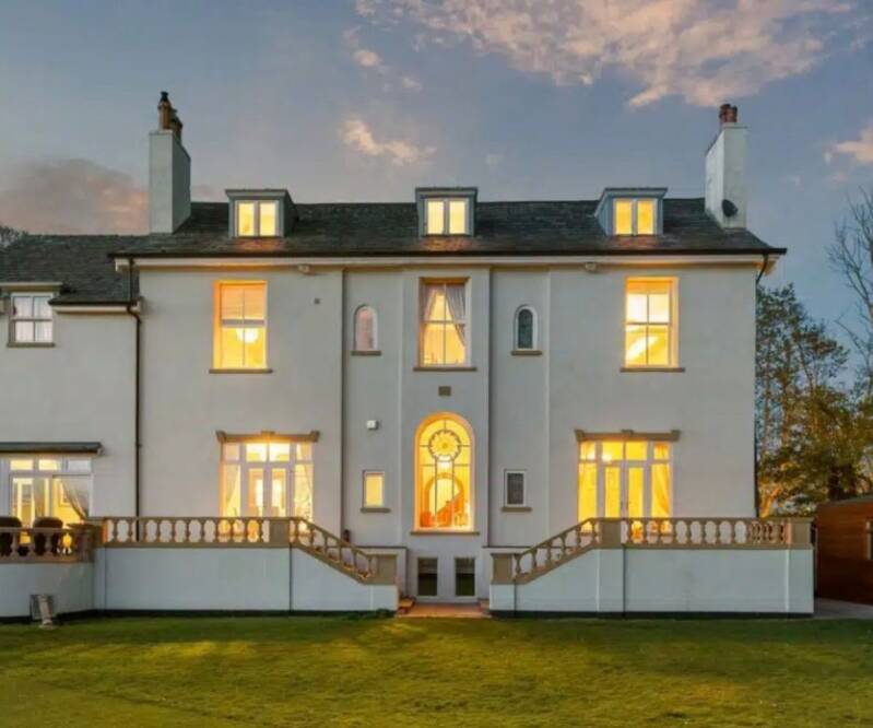 Elegant two‑storey home with warm exterior lighting at dusk, reflecting the premium, welcoming feel of local property expertise.