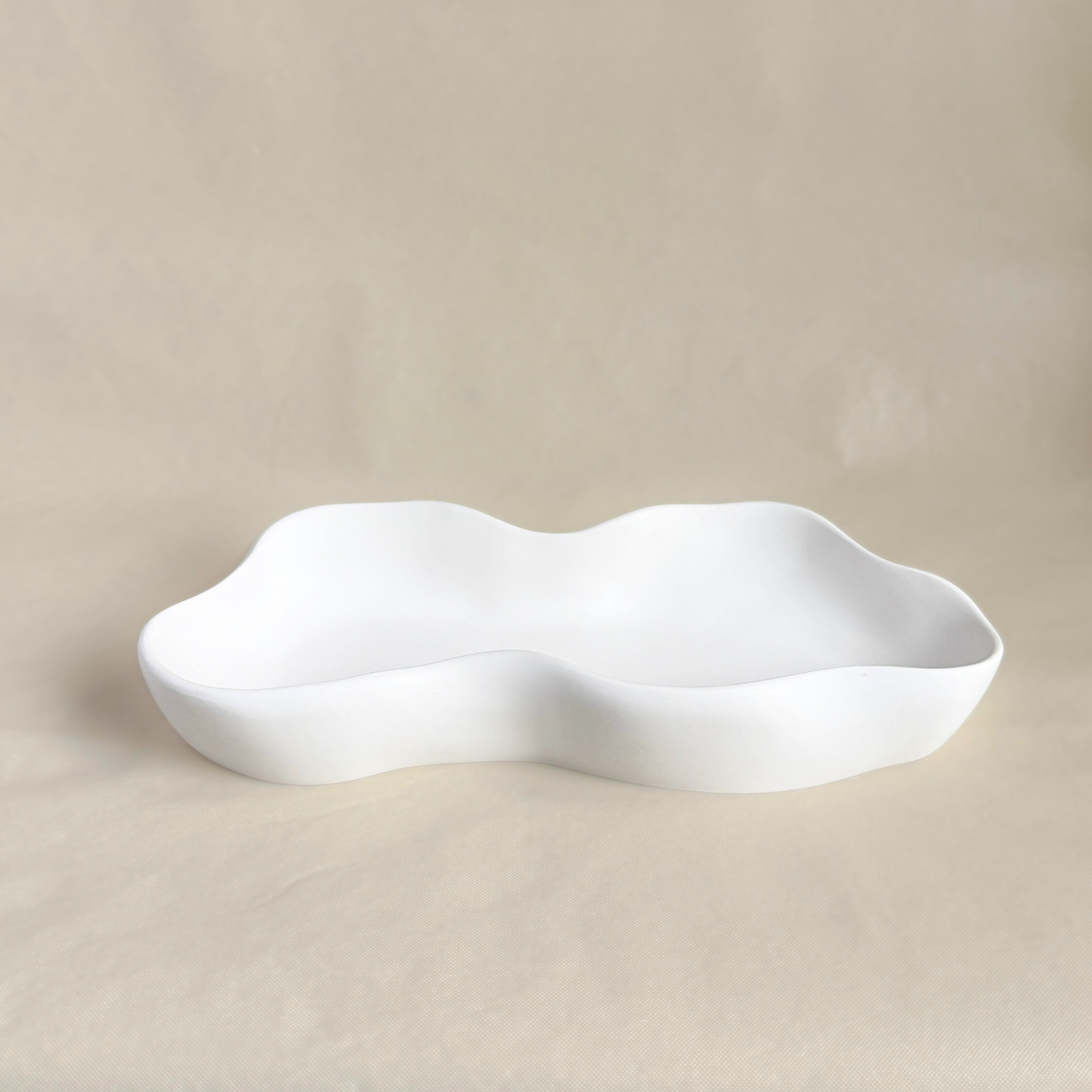 Golvende, onregelmatige schaal. Minimalistische decoratie van porseleingips