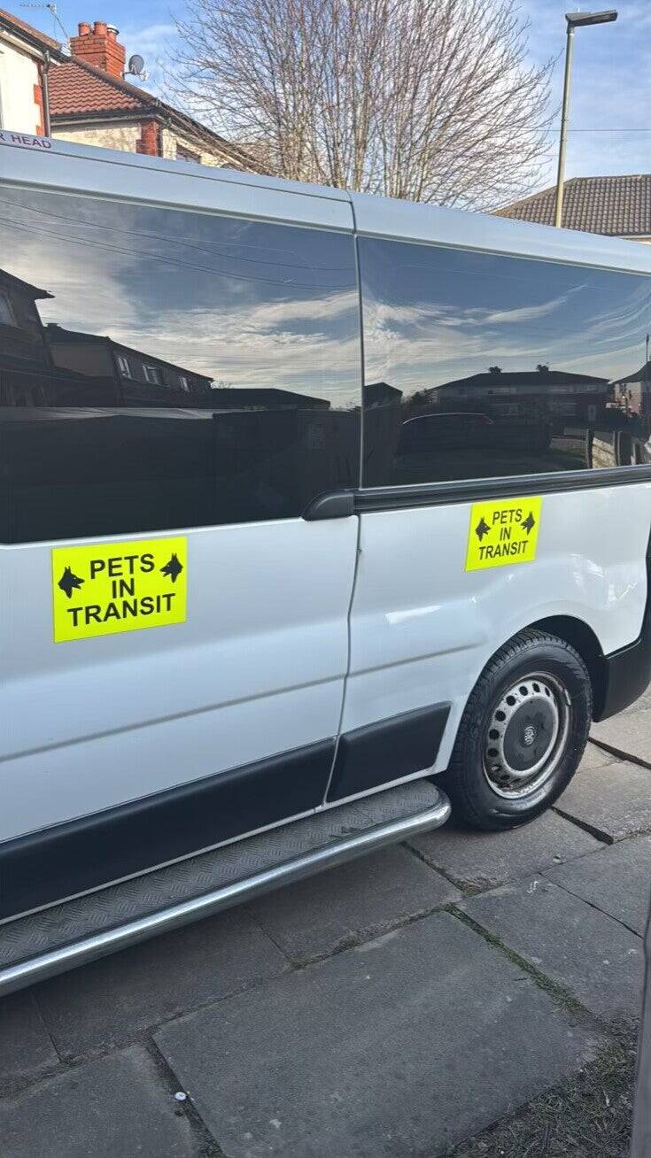 White minibus with pets in transit on the door