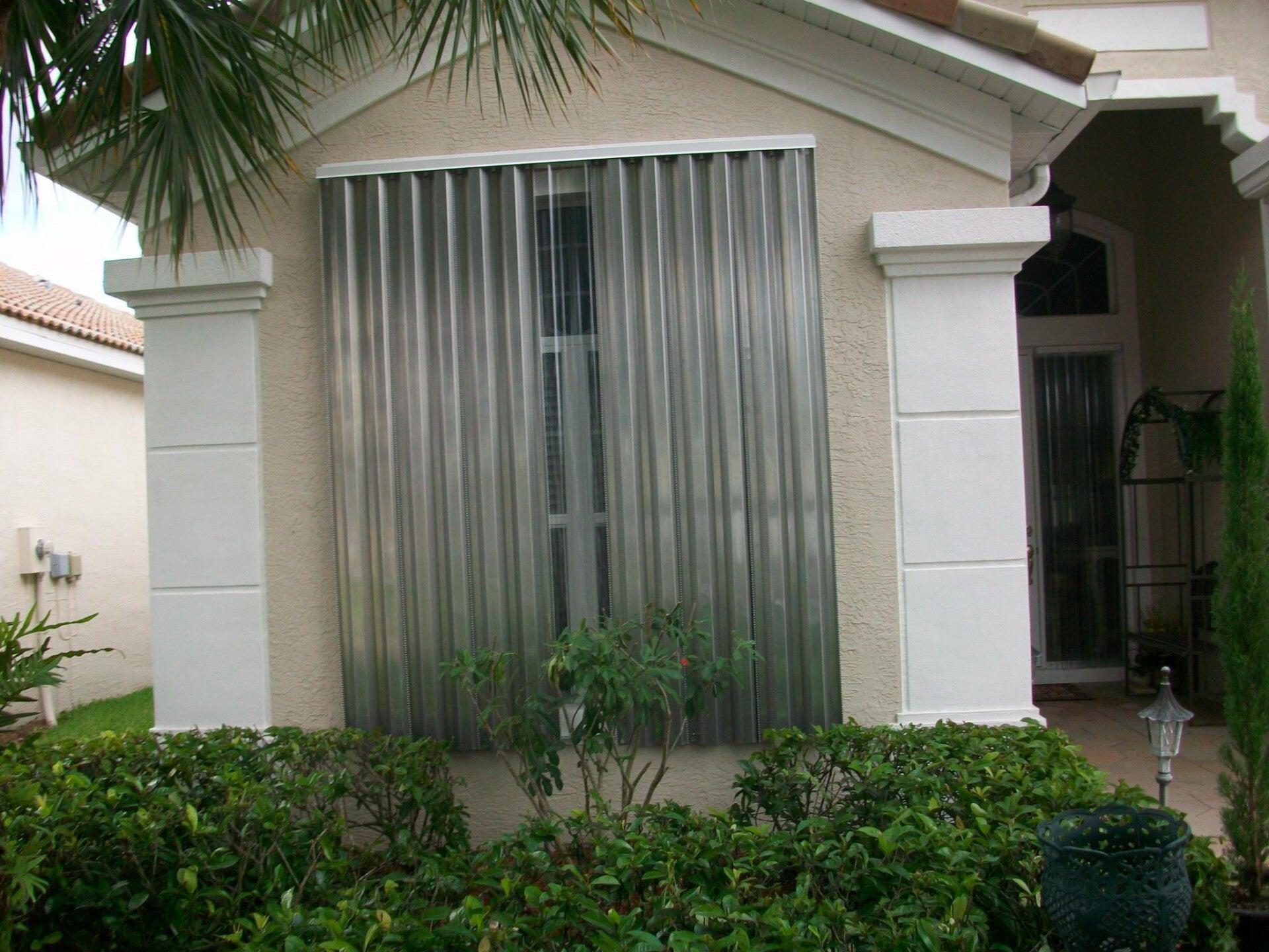 Storm panel shutters w/ tracks at top & bottom