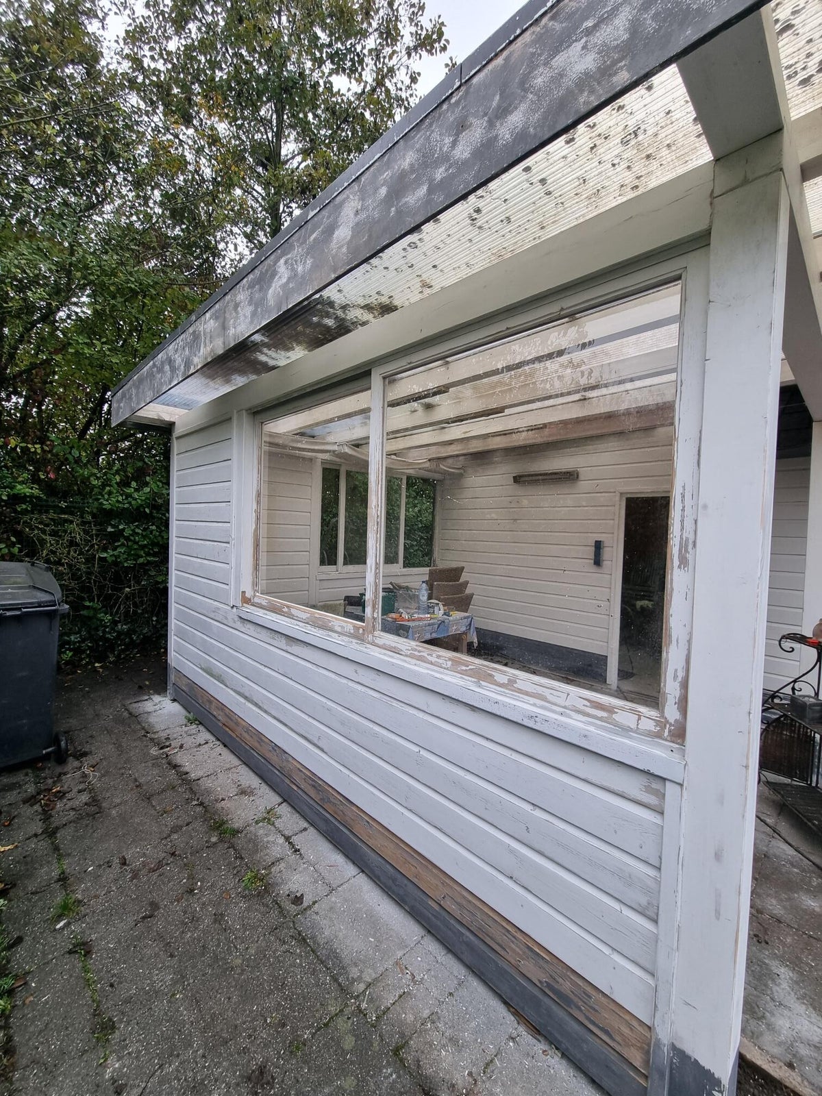 Dezelfde bungalow voor het schilderen, met afbladderende verf